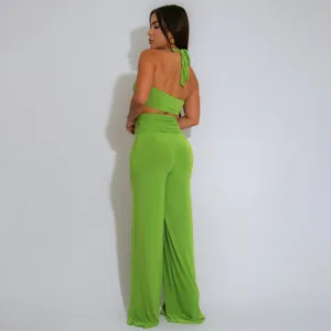Back view detail of a vibrant lime green halter neck two-piece set with wide-leg trousers