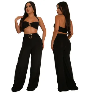 Professional studio shot of a sexy black halter top and wide-leg pants set with gold heart buckle