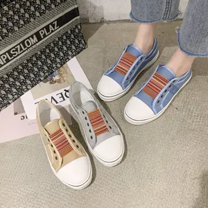 Detail view of casual women's canvas sneakers with colorful elastic bands in multiple colors