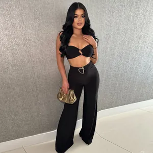 Full-body shot of the two-piece black set featuring a bandeau top and wide-leg pants