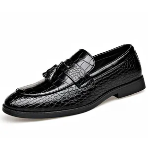 Elegant black men's loafers featuring crocodile pattern and stylish tassel detail