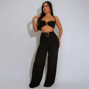 Elegant black sexy halter neck two-piece crop top and wide-leg pants set with gold buckles