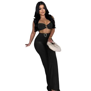 Sexy black two-piece set featuring tube top and high-waisted pants with gold buckles