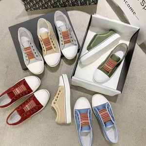 Variety of colorful casual canvas sneakers with elastic rainbow straps on display