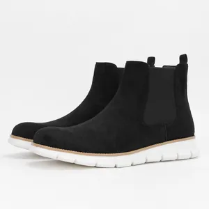 Side view of black suede men's Chelsea boots with lightweight white sole
