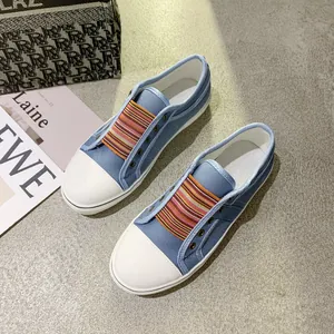 Blue casual women's canvas sneakers with colorful elastic strap and round white toe cap