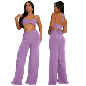 Chic lavender two-piece set featuring a halter neck top and wide-leg trousers with gold buckles