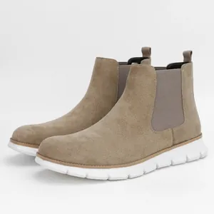 Detail shot of men's taupe suede Chelsea boots featuring comfortable white thick soles.