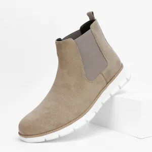 Side view detail of a men's tan suede Chelsea boot featuring a thick white sole
