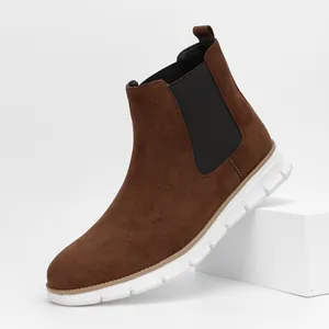 Detail view of brown suede men's Chelsea boots featuring a lightweight white sole