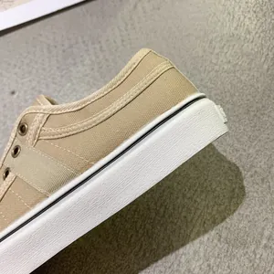 Close-up of khaki canvas sneaker showing thick white rubber sole and quality stitching