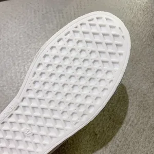Close-up of durable white waffle pattern rubber sole on women's canvas shoes