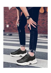 Black chunky platform sneakers worn on a street for lifestyle display