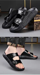 Close-up of black foam sandals with double buckles and soft sole worn by model