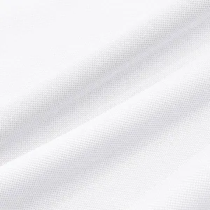 Macro detail of white breathable mesh fabric used for quick-dry athletic polo shirts