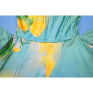 Detailed macro shot of floral print and waist stitching on turquoise satin jumpsuit garment