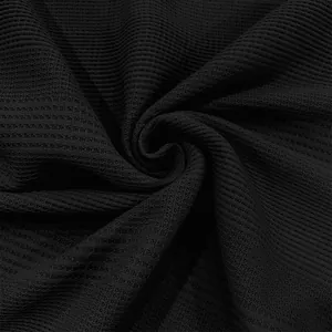 Primer plano de la tela de punto waffle negra transpirable para polos premium