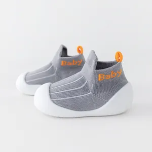 Comfortable grey breathable baby walking shoes with soft white soles and orange accents