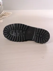 Close-up showing the durable non-slip rubber lug sole of these black platform loafers