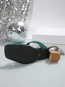 Sole detail of green square toe chunky heel slippers with size 37 mark and gold trim