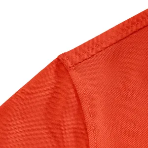 Macro view of shoulder seam and high-quality stitching on orange mesh polo shirt