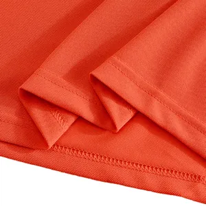 Macro view of the precision stitching and mesh fabric of an orange quick-dry polo shirt.