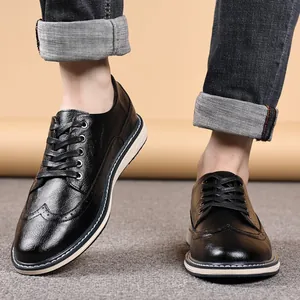 Classic black men's brogue shoes with decorative carved leather and a thick white sole