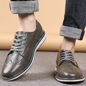 Men's classic Brogue carved leather casual shoes in grey-brown with wingtip detail.