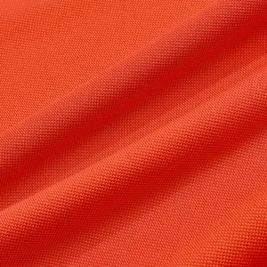 Close-up detail of breathable orange mesh fabric for summer polo shirts.