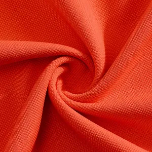 Close-up view of breathable orange pique mesh fabric texture for men's summer golf polo shirts
