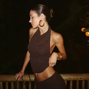 Detail view of a sexy brown halter neck and backless top worn on a night terrace