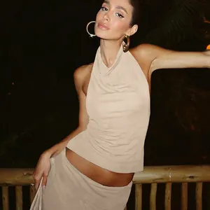 Close-up of a stylish beige halter neck backless top and matching slim fit skirt set