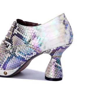 Close-up of holographic snake pattern texture on punk style high heel shoe heel