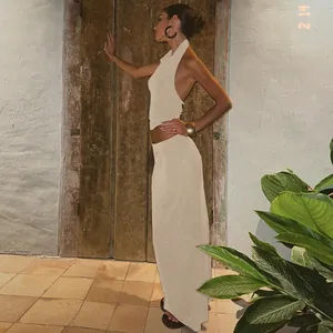 Elegant beige halter top and maxi skirt set with backless detail for women.