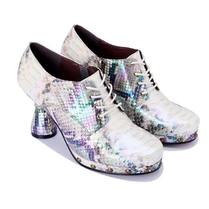 Detailed view of iridescent snakeskin pattern on punk style platform high-heeled shoes