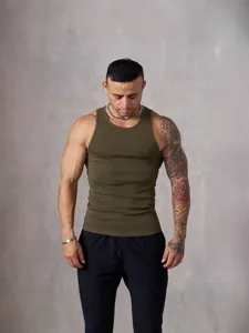 Muscular man wearing olive green ribbed knit tank top for gym and fitness workout
