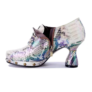 Detailed view of punk snakeskin print high heel with iridescent finish and metal studs
