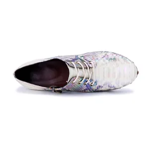 Top view detail showing iridescent snakeskin pattern, white laces and side zipper closure.