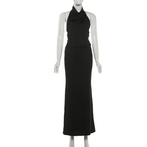 Detailed view of black halter neck top and slim fit maxi skirt set on mannequin