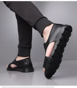 Close-up view of black leather men's sandals showing the non-slip sole and texture