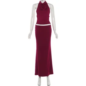 Full view of a burgundy two-piece set featuring a halter top and maxi skirt on a mannequin