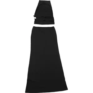 Detailed flat lay of black halter backless top and matching slim-fit maxi skirt set