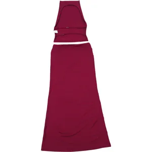 Detail showing the backless construction of a dark red halter top and skirt set