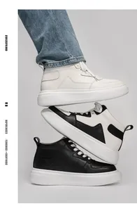 Close-up of stacked mid-top platform sneakers in white, black and white, and black colors.