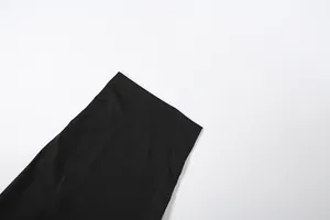 Detailed macro view of the waistline and fabric texture of a slim-fit black midi skirt