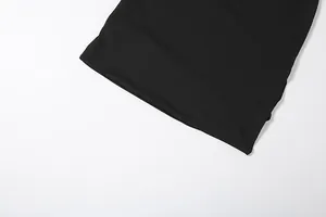 Close-up detail of the hem on a black solid color sexy halter skirt set for women