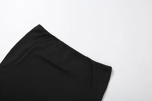 Close-up macro shot of the elastic waistband on a sexy solid black slim fit midi skirt.