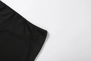 High-quality close-up of the smooth black fabric and waist detail of this slim fit skirt set