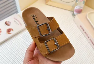 Primer plano de sandalias de gamuza marrón para niñas con dos hebillas ajustables