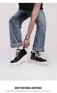 Detail view of men's black mid-top thick-soled sneakers with 6cm height increase worn with jeans.